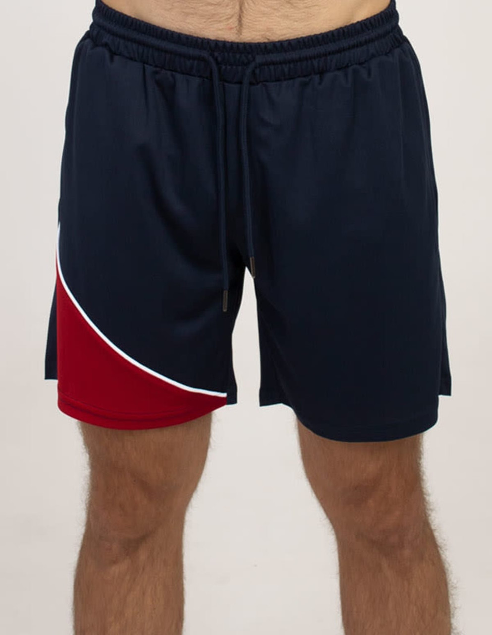 Sports shorts in navy blue with a red panel and white detailing, featuring an elasticised waistband and drawstring.