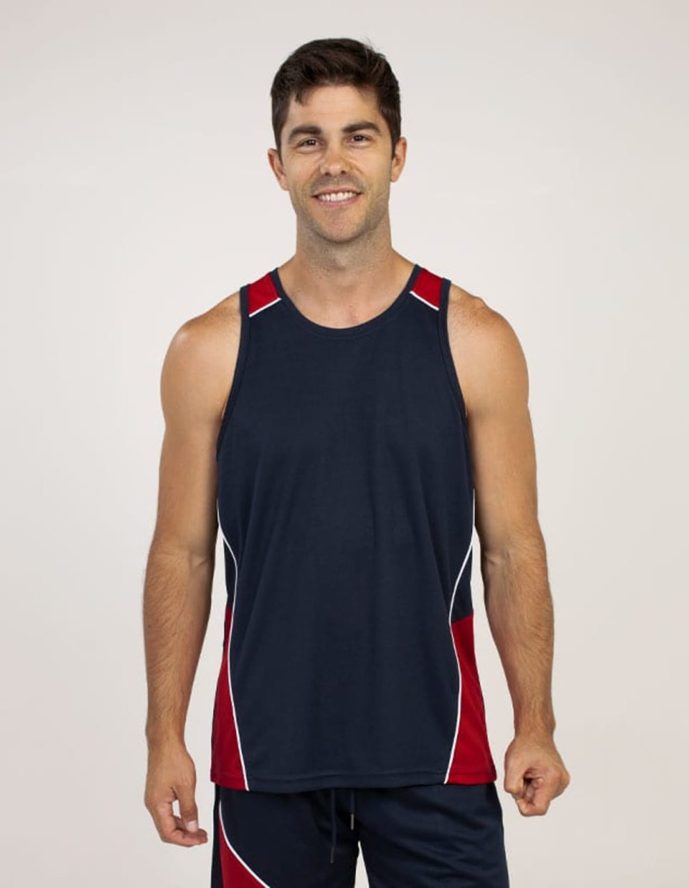A navy blue singlet with red accents, featuring a logo, worn by a smiling male model.