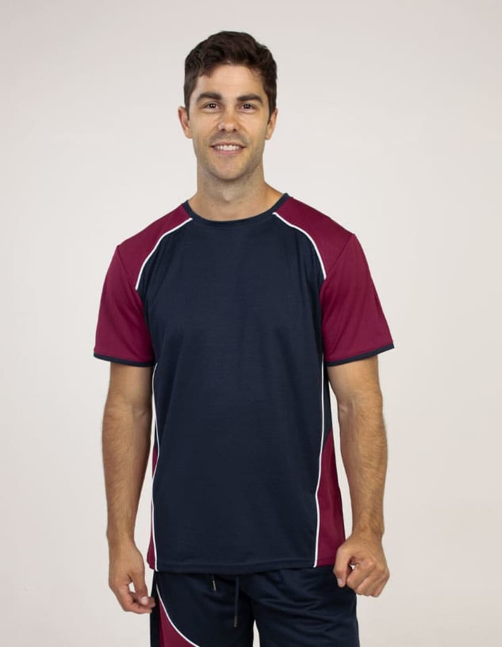 A blue and maroon T-shirt with contrasting piping, featuring a model smiling in a plain background.