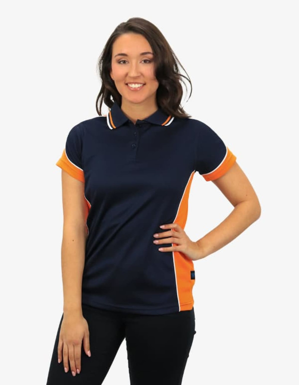 A navy polo shirt with orange accents and a logo, worn by a model standing with a smile.
