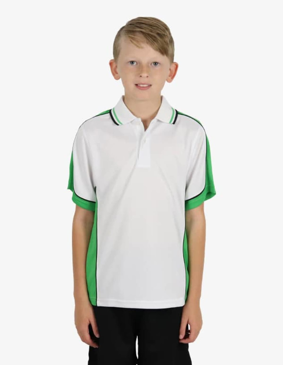 A boy stands wearing a white polo shirt with green accents and a logo on the chest.