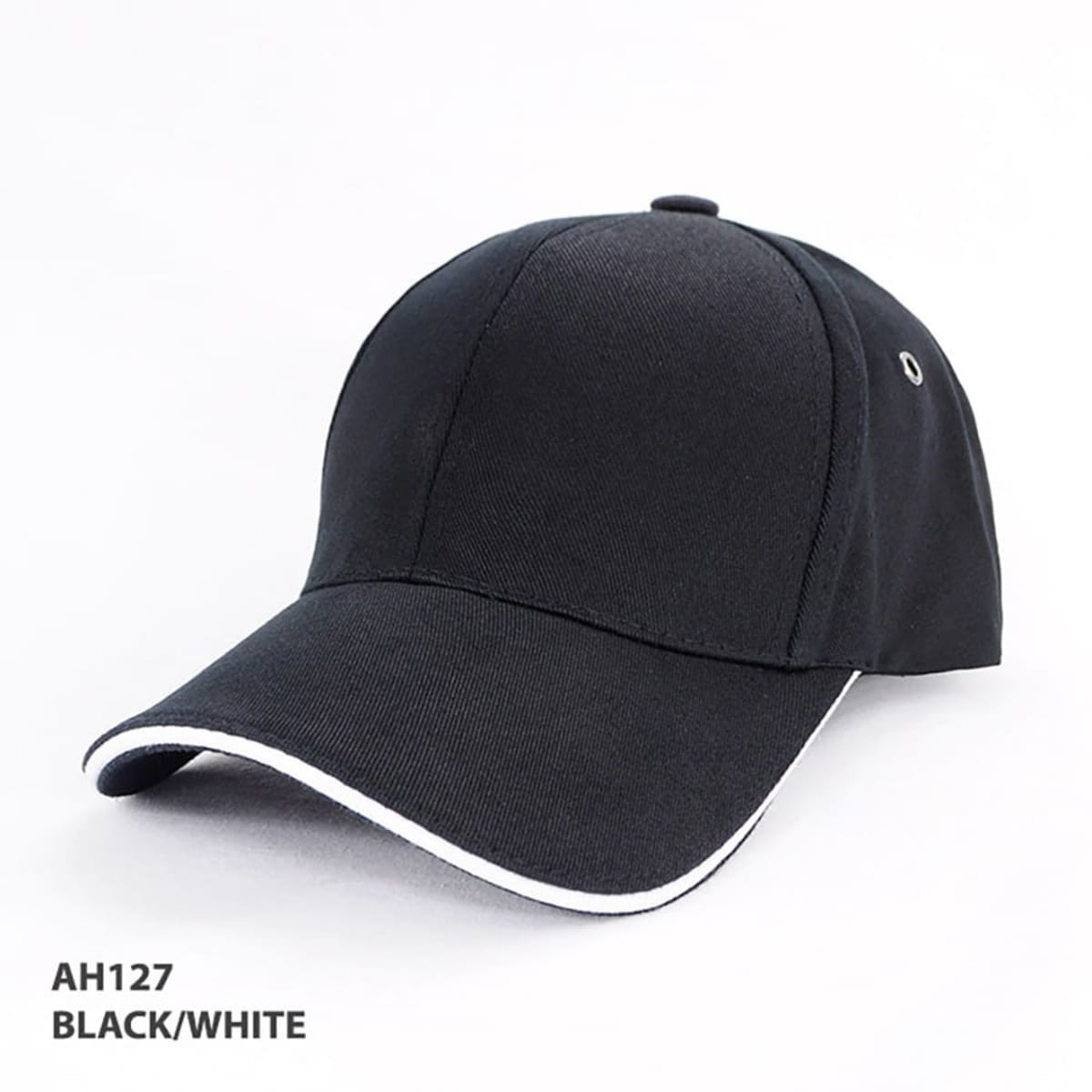 A black and white organic cotton sandwich cap with a curved brim, featuring a logo on the side.