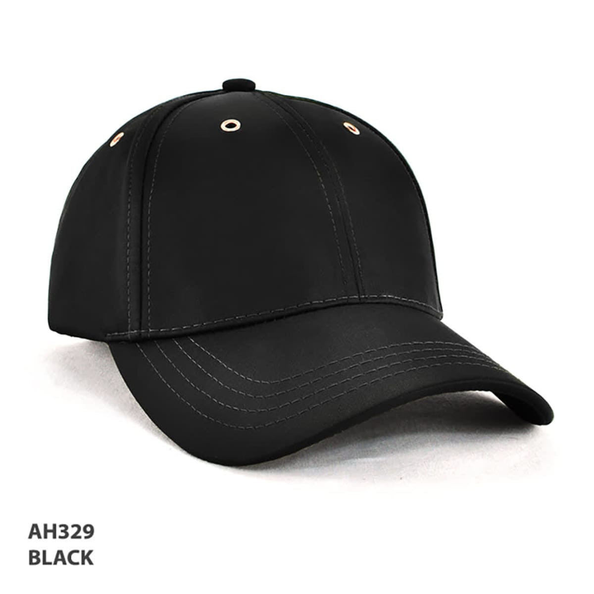 A black cap with a curved brim, featuring gold eyelets and stitching, and a logo on the front.