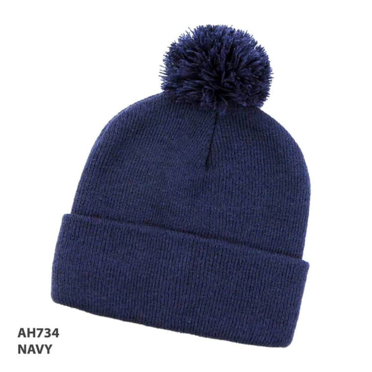 A navy beanie with a pom-pom on top and a folded cuff, featuring a logo.