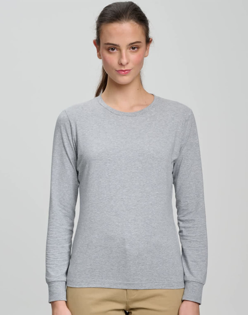 A long-sleeve tee shirt in light grey, featuring a round neckline and a fitted design. It has a logo on the chest.