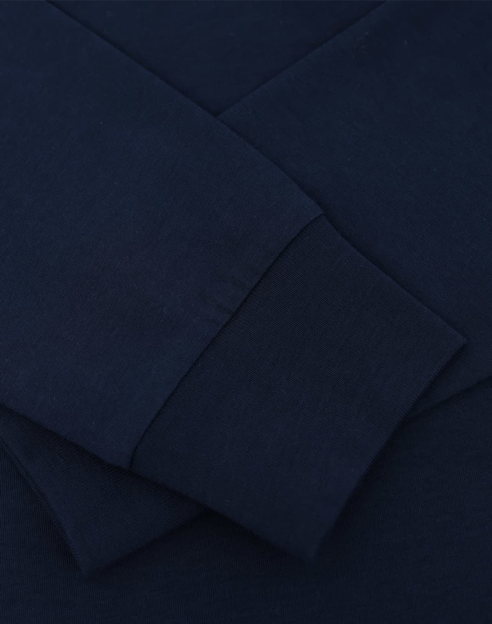 A navy blue long sleeve tee shirt featuring close-up details of the fabric and cuffs, with a logo present.