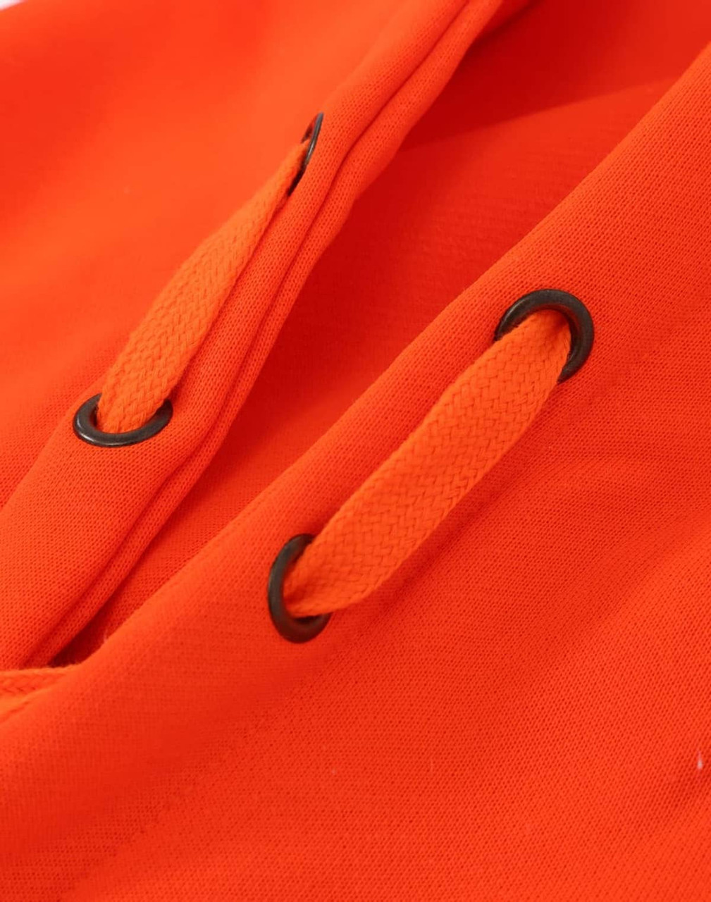 A close-up of an orange fleece hoodie with black eyelets and drawstrings. The fabric appears water resistant.