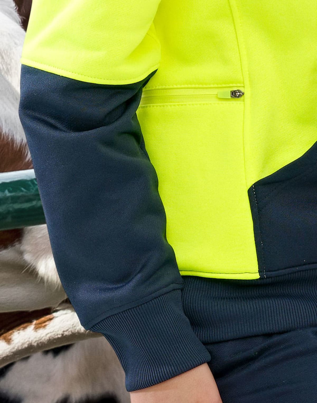A bright yellow and dark navy fleece hoodie featuring a zippered pocket and ribbed cuffs. It has a logo on it.
