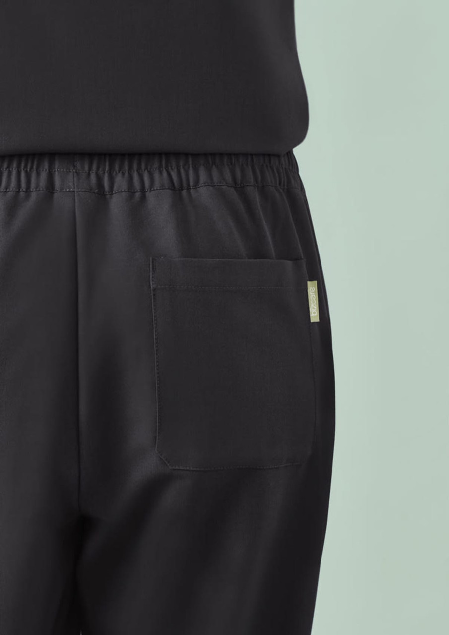 A close-up of black women's jogger scrub pants featuring a back pocket and elastic waistband.