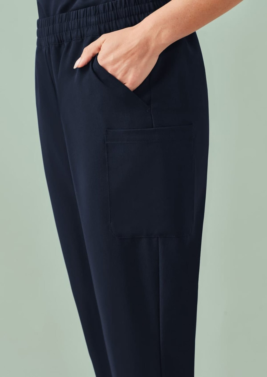 A navy blue women's jogger scrub pant featuring a side pocket and an elastic waistband.
