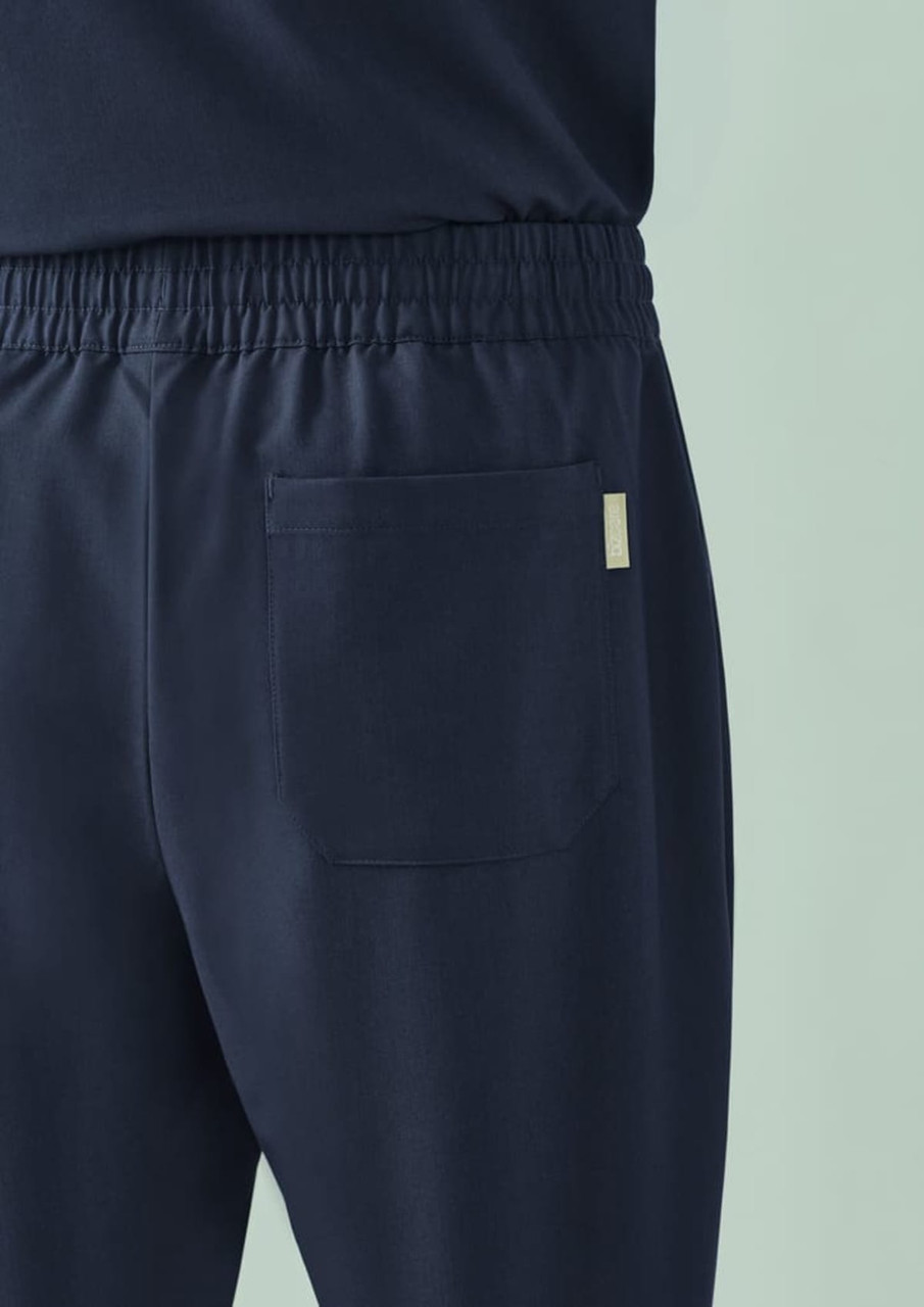 Navy unisex straight leg scrub pant with an elastic waistband and a back pocket. Includes a logo.