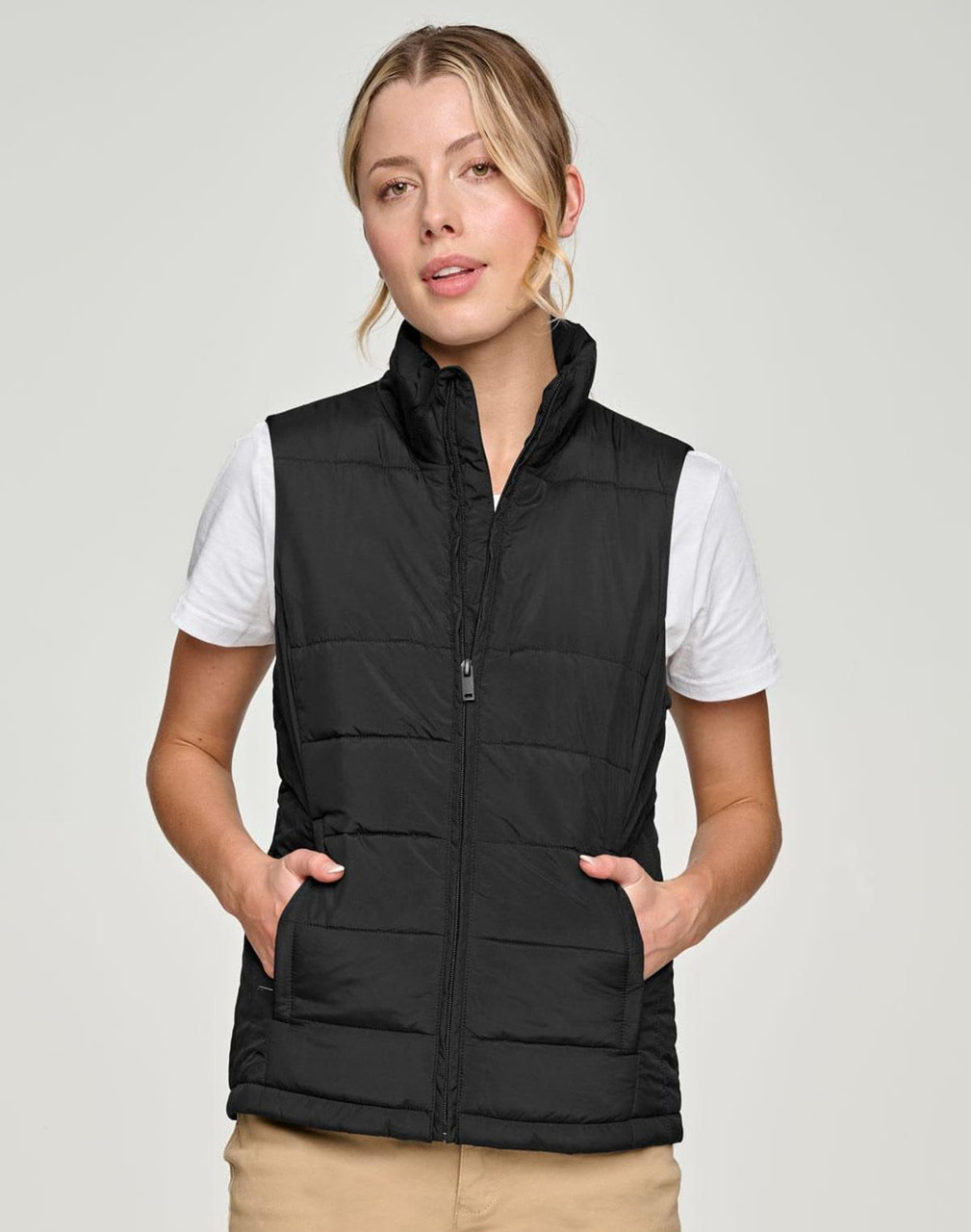 A black insulated puffer vest with a 3D cut design, featuring side pockets and a front zip.