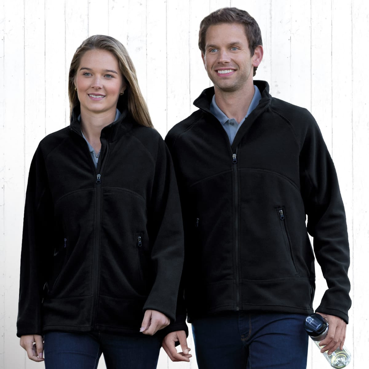 Two people wearing black Explorer Microfleece Jackets, featuring zippered pockets and standing against a neutral background.