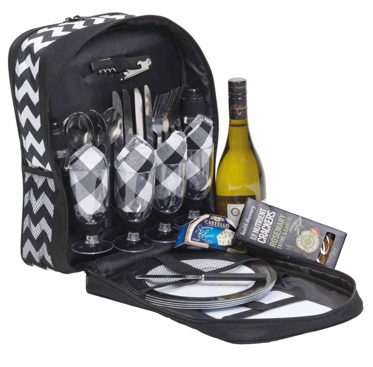 A picnic set featuring a black and white chevron bag, wine bottle, glassware, cutlery, and dinner plates.