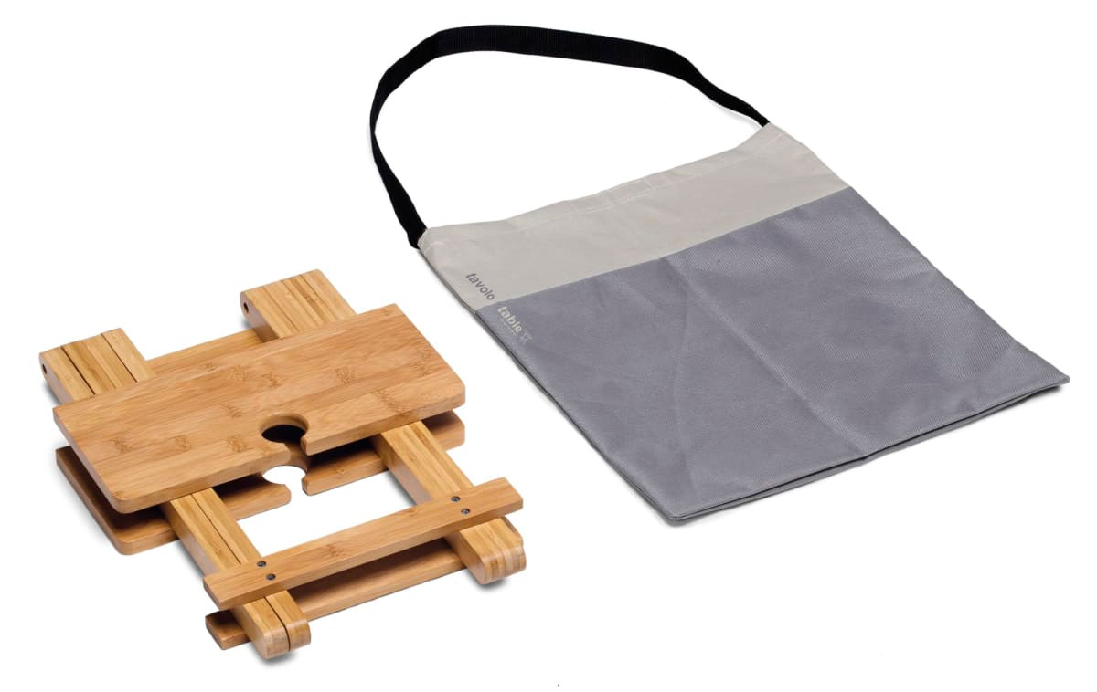 A bamboo table with a grey carrying bag. The table features a centre hole, ideal for leisure use.