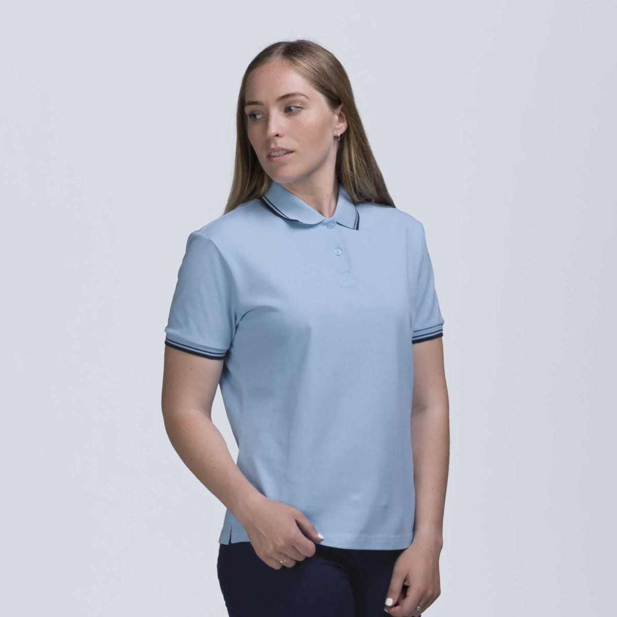 A light blue women's polo shirt with a collar, featuring contrast stripes on the sleeves and a logo.