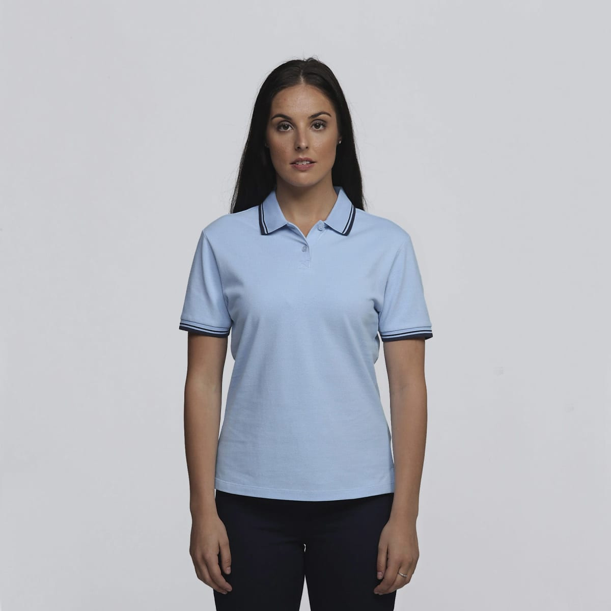 A light blue women's polo shirt with contrasting stripes on the collar and sleeves. It features a logo on the chest.