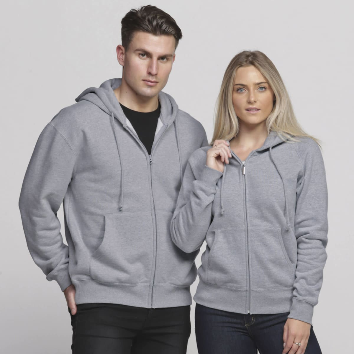 A grey vintage hoodie with a zip front, featuring a hood and two front pockets, displayed on a male and female model.