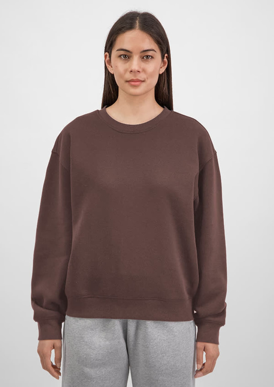 A brown crew sweatshirt for women, featuring a relaxed fit and long sleeves, displayed on a model.