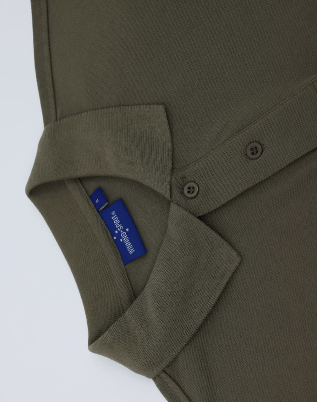 An olive green men's classic cotton/poly pique short sleeve polo, featuring a collar and buttons. It has a logo.
