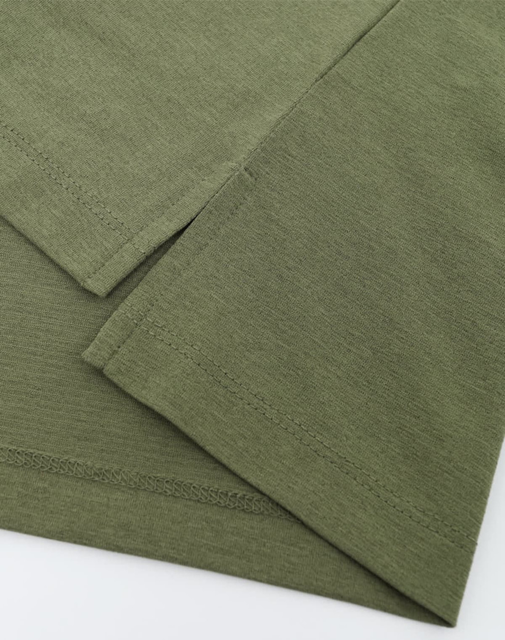A close-up view of an olive green polo shirt highlighting the fabric texture and stitching details. The garment has a logo.