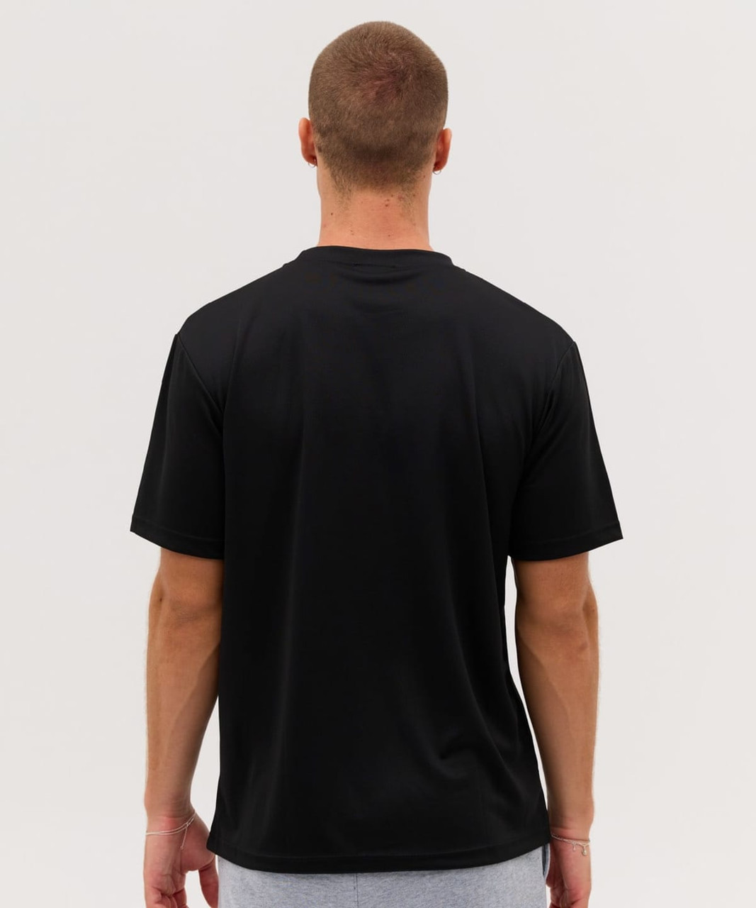 A black T-shirt featuring a standard crew neck and short sleeves, shown from the back. It includes a logo.