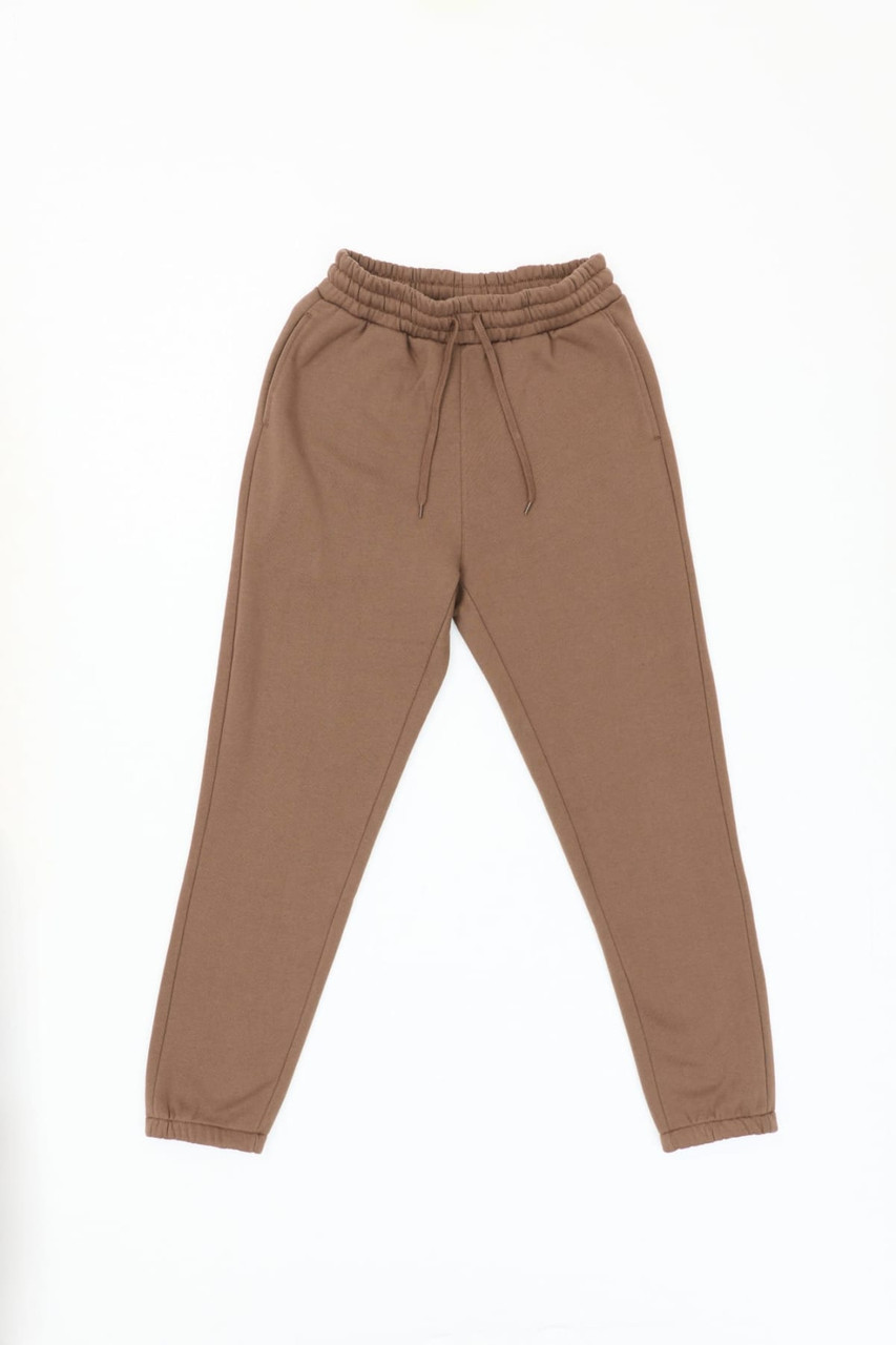 A pair of brown track pants with an elastic waistband and cuffed ankles. The pants feature a logo.