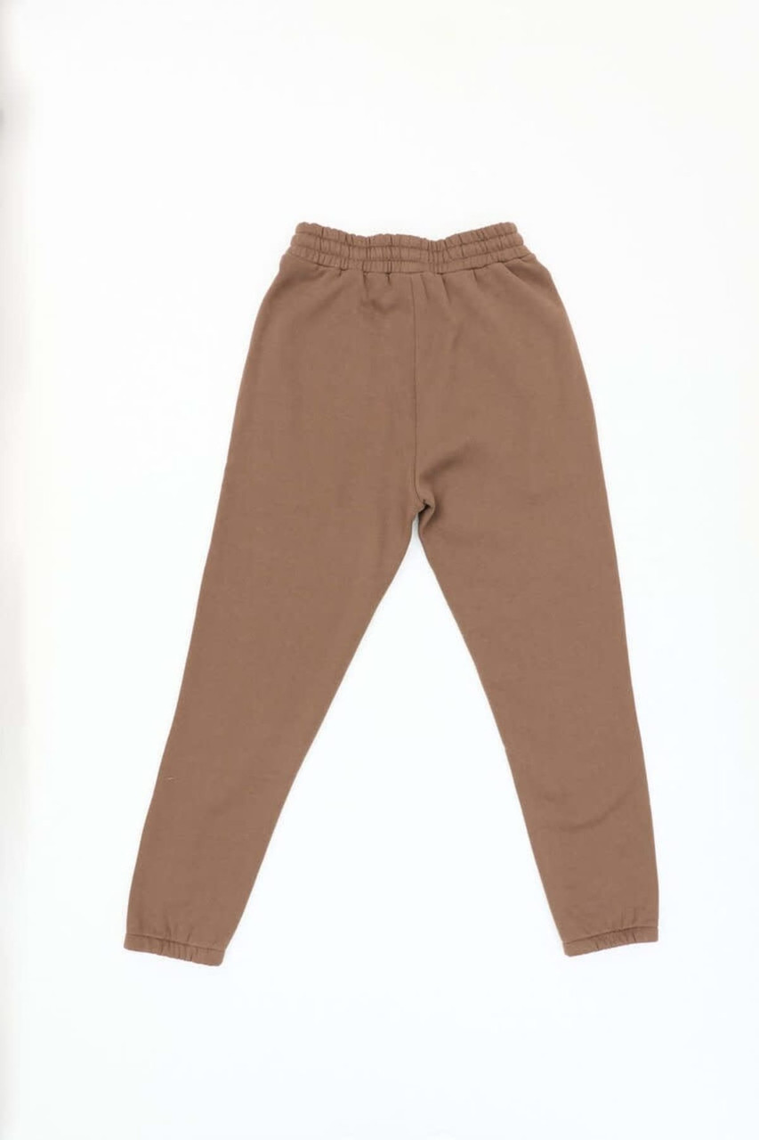 Brown track pants with an elastic waistband and tapered legs, featuring a simple design.