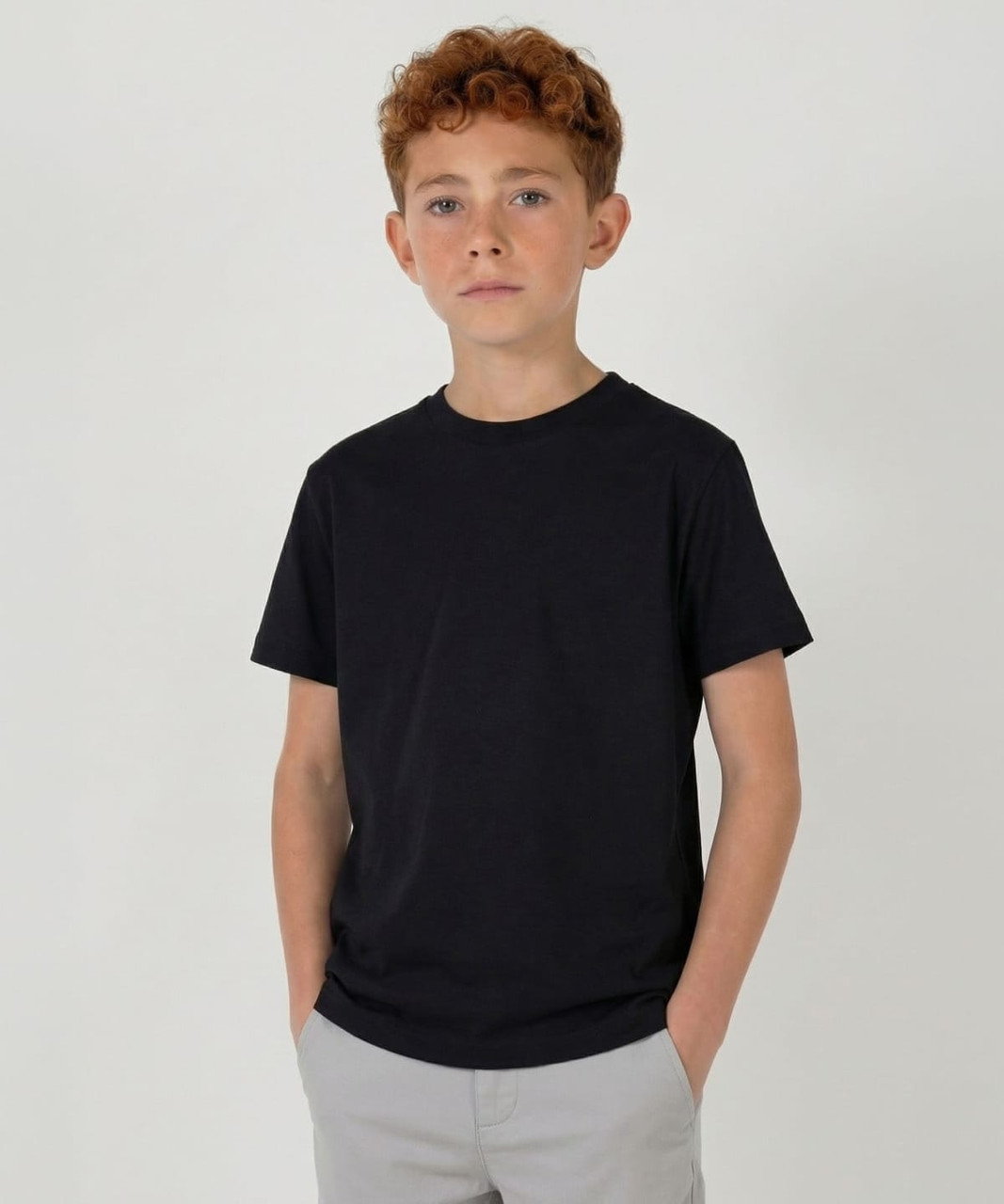 A black youth t-shirt with a classic design, featuring a round neckline and short sleeves, paired with light grey shorts.