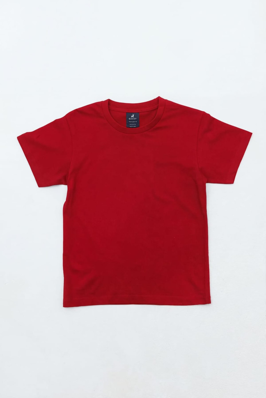 A red youth essential tee featuring short sleeves and a simple design, with a brand logo visible on the label.