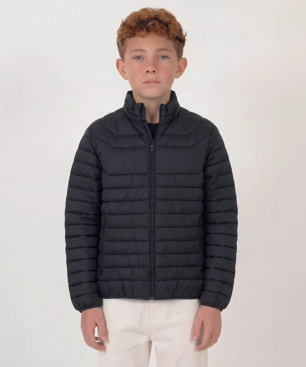 A black puffer jacket with a zip front and high collar, suitable for youth sizes, displayed on a model.