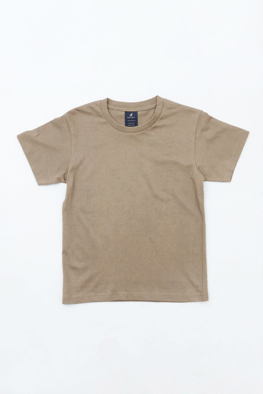 A tan youth t-shirt with short sleeves and a crew neck, featuring a logo on the label.