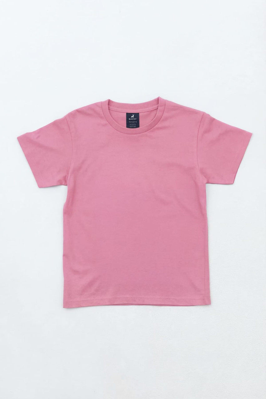 A pink youth t-shirt with short sleeves and a tag, featuring a simple design.