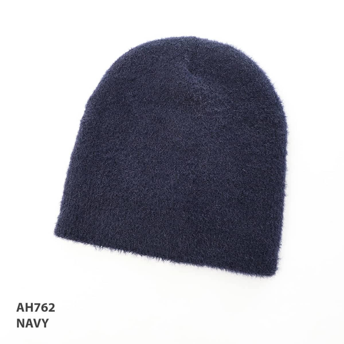 A navy blue shaggy beanie with a soft texture, featuring a logo.