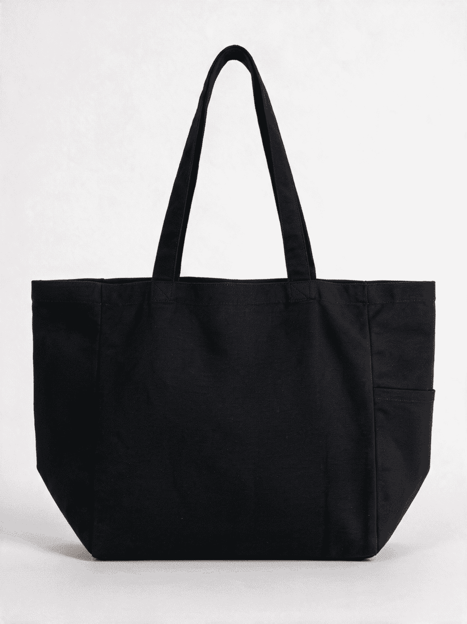 A black canvas tote bag featuring two shoulder straps and a side pocket, with a simple design and a logo.