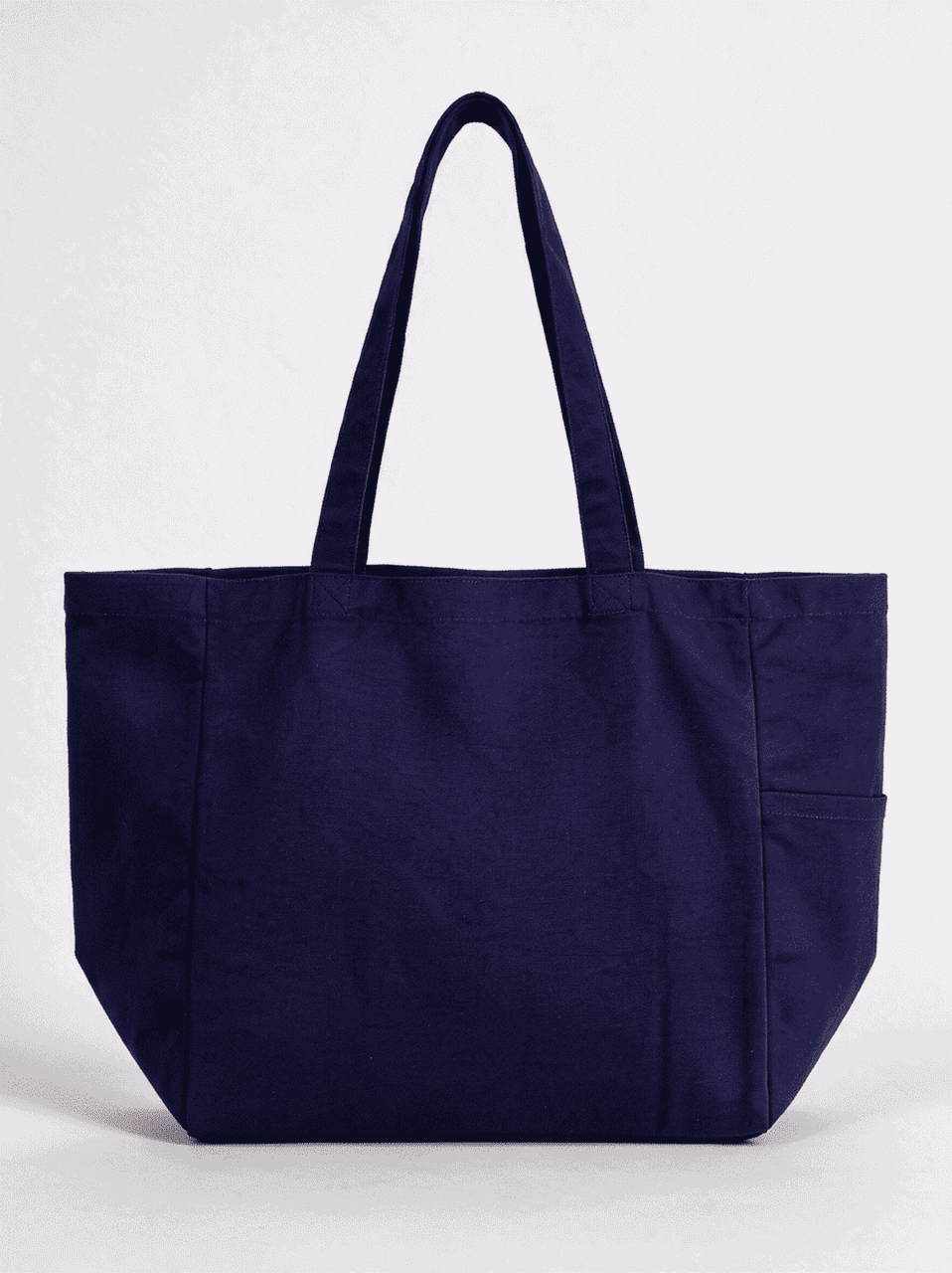 A navy blue canvas tote bag with two handles and a side pocket. It features a branding logo.