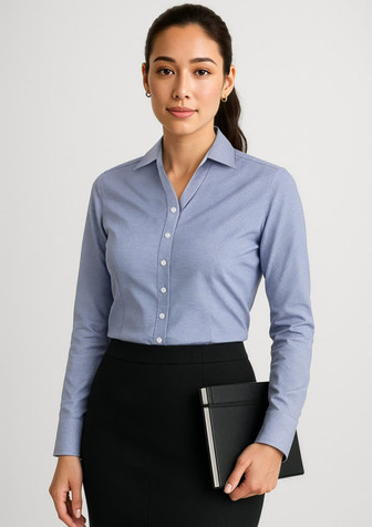 A long sleeve, button-up shirt in light blue, featuring a slim fit and a logo. Suitable for formal attire.