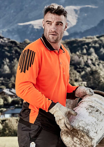 An orange and black long sleeve polo shirt featuring a logo, worn by a man carrying a bucket outdoors.