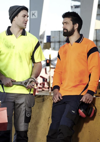 Two men wearing short-sleeve polo shirts in bright yellow and orange, featuring logos and workwear-style designs.