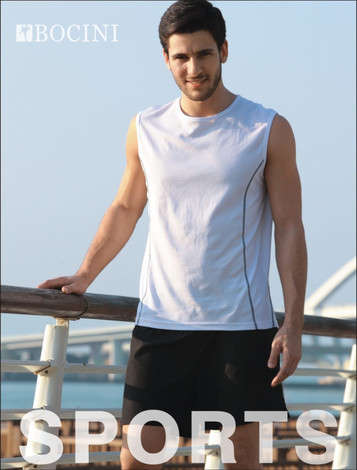 A man in a white sleeveless tank top with black accents stands by a railing, wearing black shorts. The image has a logo.