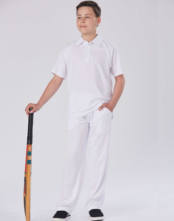 A pair of white kids' cricket pants displayed on a model holding a cricket bat, set against a plain background.