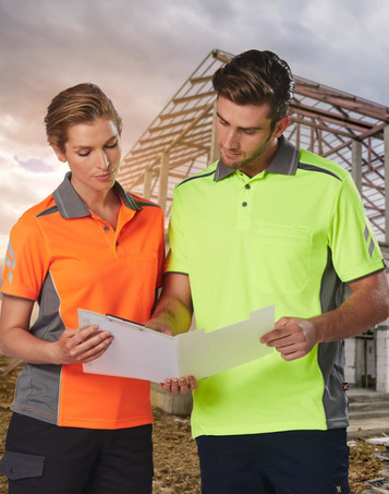 Two individuals wear the AIWX Vented Cooldry Polo shirts in bright orange and high-visibility yellow, with grey accents.