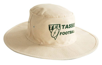 A faded beige canvas hat with a wide brim, featuring a logo on the front.