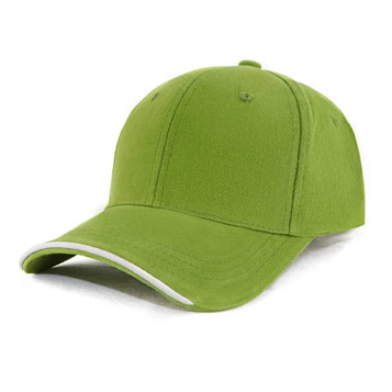 A green cap with a curved brim and a logo, featuring a contrasting trim along the edge.