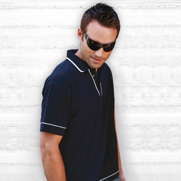 A black polo shirt with white trim displayed on a model wearing sunglasses. The shirt has a collar and a logo.