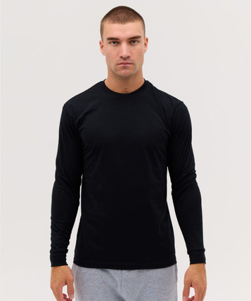 A long sleeve black tee features a fitted design and includes a logo. Model is wearing grey pants.