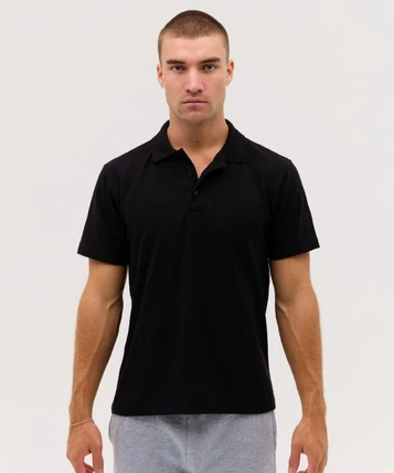 A black polo shirt with a collar and short sleeves, featuring a logo on the chest.
