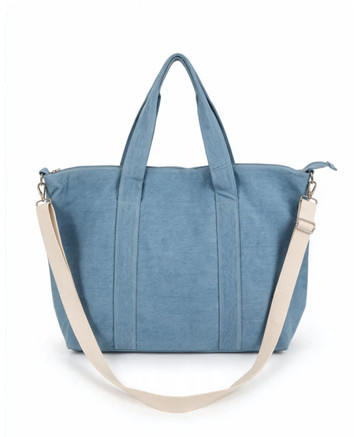 A blue duffle bag with two handles and a detachable strap, featuring a simple design and a logo.