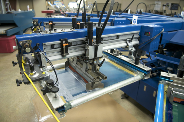 Screen printing ink being pulled across a mesh screen
