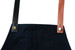 A black apron with changeable PU cross-back straps in black and brown, featuring metal buttons.